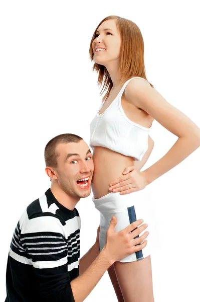 Cheerful man listening the belly of his pregnant wife — Stock Photo, Image