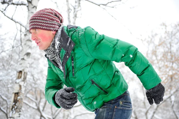 Closeup portrait of young man running in winter park — Stock Photo, Image