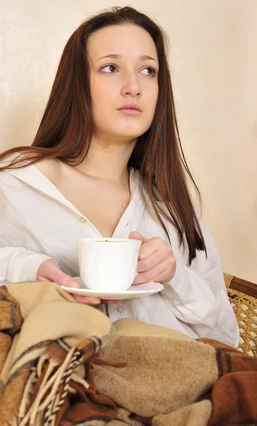 Evde çayını yudumlayan genç bir kadın. — Stok fotoğraf