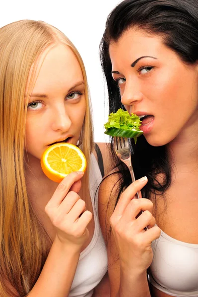 Two beautiful slender girls eating healthy food — Stock Photo, Image