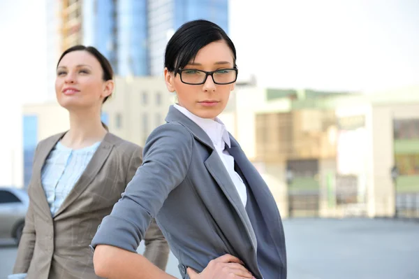 Portrait of a beautiful business woman with a female colleague — Stock Photo, Image