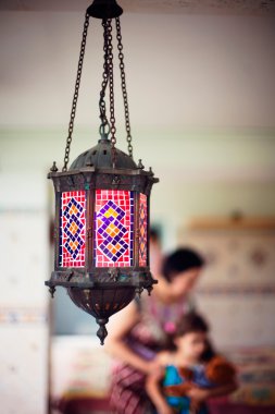 Artistic lifestyle photo of happy family: aged metal lantern on clipart