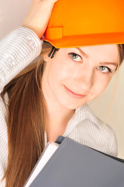 Closeup portrait of young pretty engineer woman wearing helmet — Stock Photo, Image