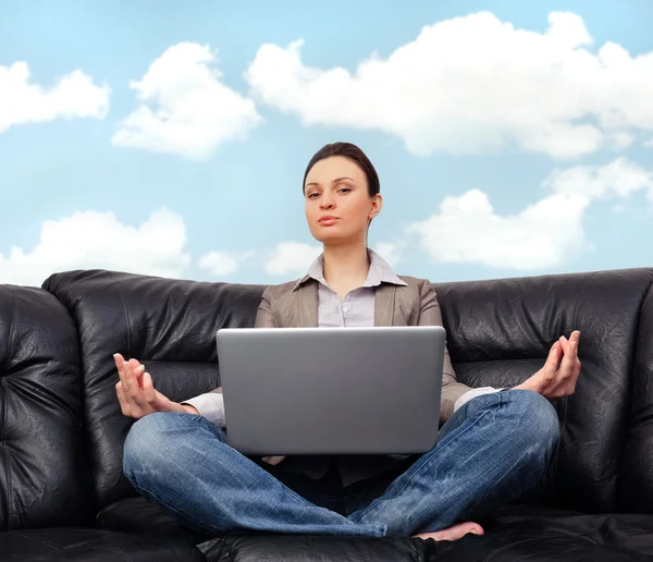 Portrait of young business woman sitting with a laptop on comfor — Stock Photo, Image