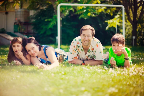 Artistic lifestyle photo of full happy family laying relaxed on — Stock Photo, Image