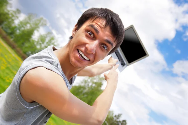 Casual young man pointing at laptop screen — Stock Photo, Image