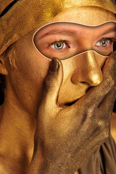 Closeup portrait of young woman in golden paint closing her mout — Stock Photo, Image