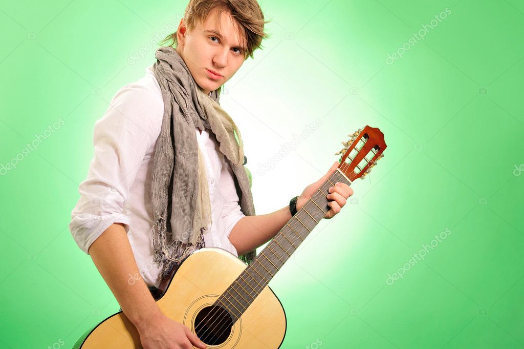 Closeup portrait of cute caucasian man playing the guitar over g