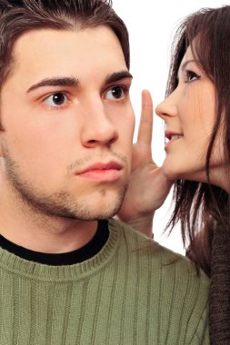 Closeup portrait of young couple of students. Woman whispering s clipart