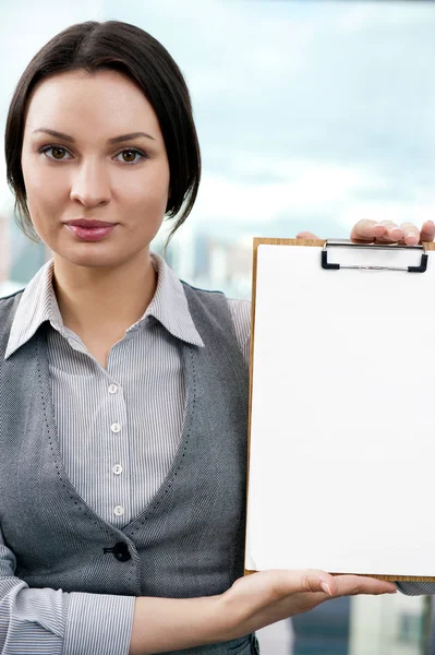 Portrait of business woman holding blank reports and looking at — Stock Photo, Image