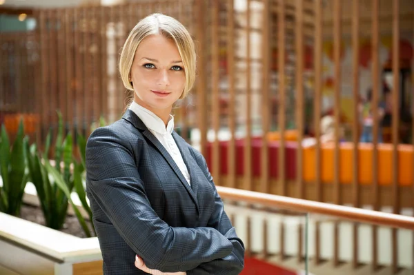 Portrait of a cute business standing woman with hands folded ins — Stock Photo, Image