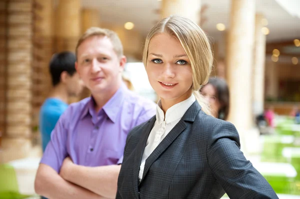Portrait of a cute business woman with colleagues at the backgro — Stock Photo, Image