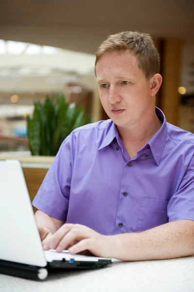 Friendly executive sitting in front of laptop — Stock Photo, Image