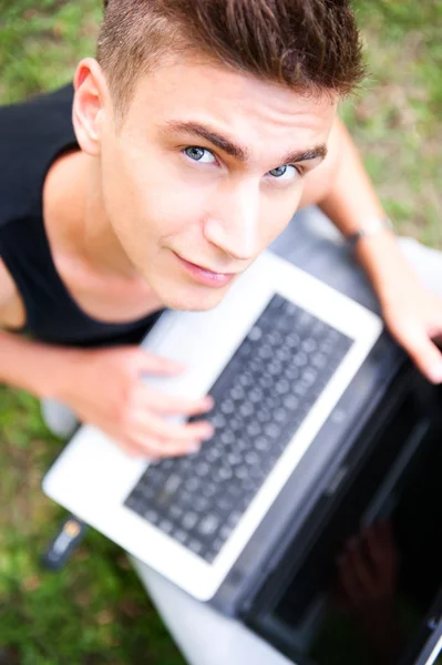 Closeup portrait of young student man using laptop and 3g usb mo — Stock Photo, Image