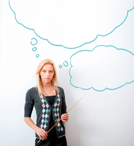 Portrait of young teacher pointing on white marker board in mode — Stock Photo, Image