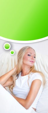 Young blond woman enjoying a sunny morning in bed clipart