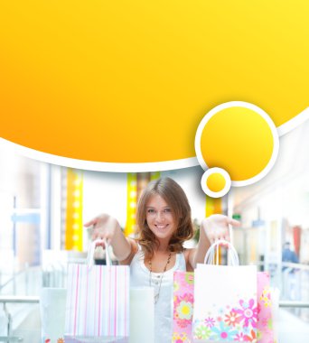 Shopping woman with lots of bags smiles inside mall. She is happ clipart