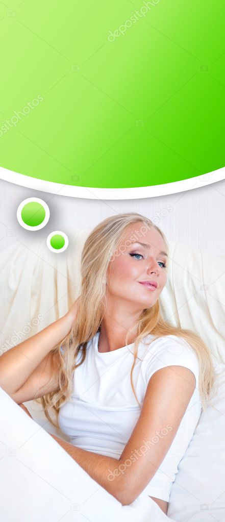 Young blond woman enjoying a sunny morning in bed. Blank balloon with lots of copyspace for your text and logo overhead.