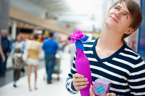 Portrait of young man inside shopping mall standing relaxed and — Stock Photo, Image