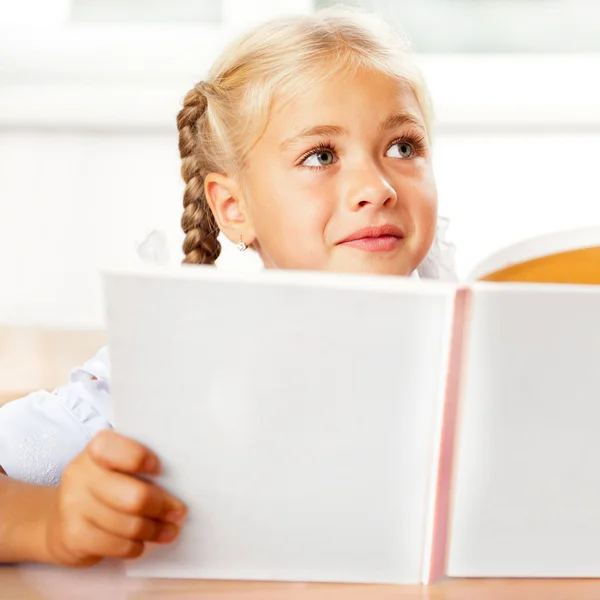 Image of smart child reading interesting book in classroom. Hori — Stock Photo, Image