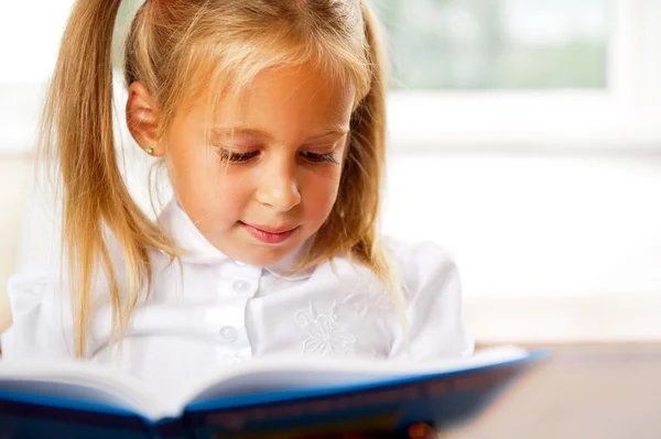Image of smart child reading interesting book in classroom — Stock Photo, Image