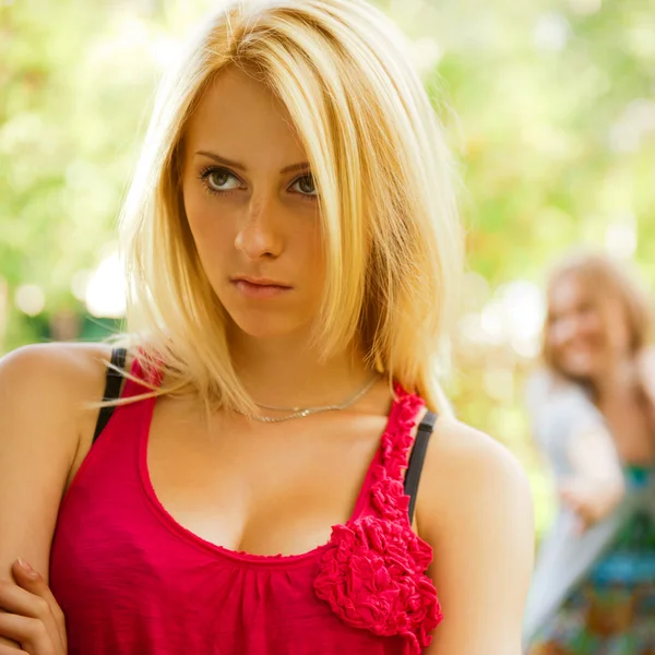 Upset teenage girl being jeered by group of the other young peop — Stock Photo, Image