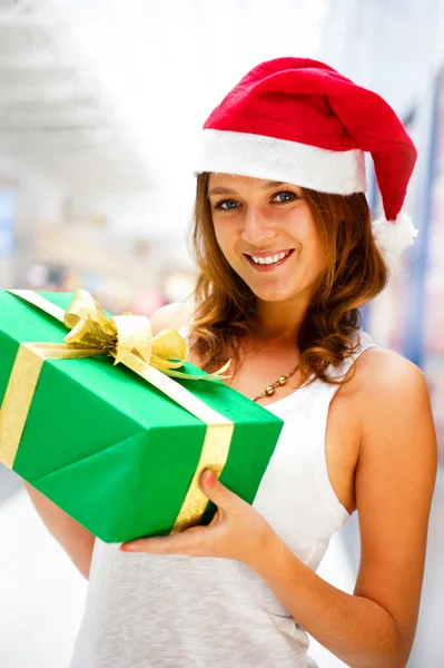 Portrait of young excited pretty woman standing inside shopping Stock Picture