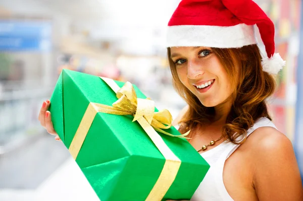Portrait of young excited pretty woman standing inside shopping Stock Photo