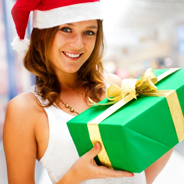 Portrait of young excited pretty woman standing inside shopping Stock Image