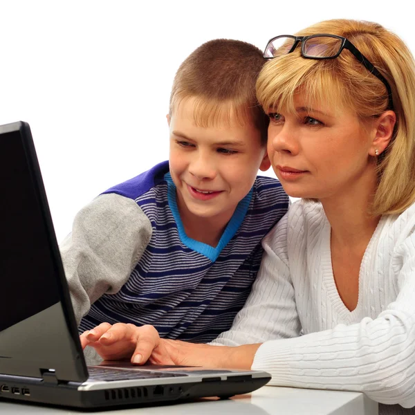 Portrait of adult woman watching as her son doing homework — Stock Photo, Image