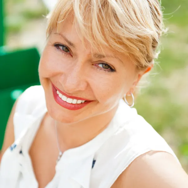 stock image Portrait of a female smiling in a park