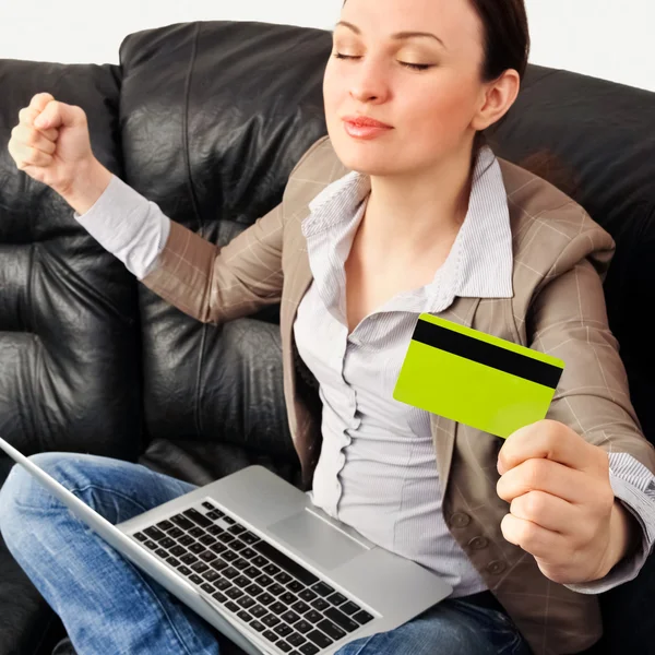 Portrait of a young woman lying on the couch and shopping from t — Stock Photo, Image