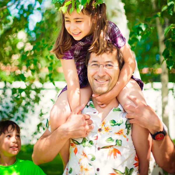 Artistic lifestyle photo of happy family: father piggyback his d — Stock Photo, Image