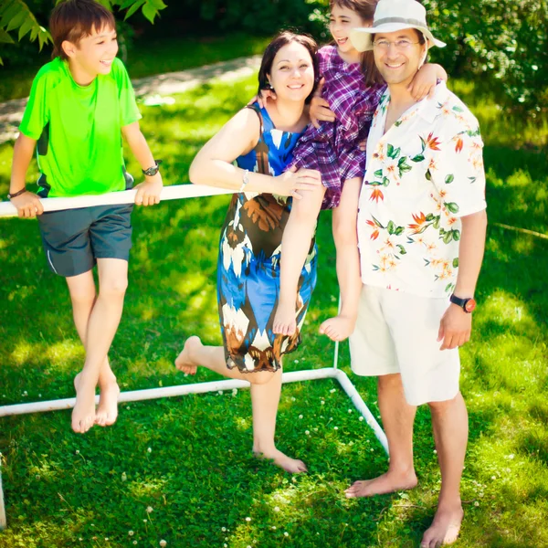 Artistic lifestyle photo of full happy family laying relaxed on — Stock Photo, Image