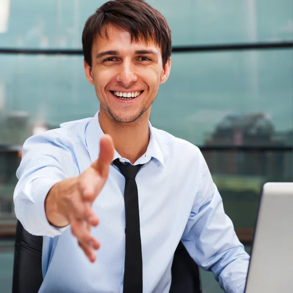 Happy mature business man offering a welcoming hand Stock Picture