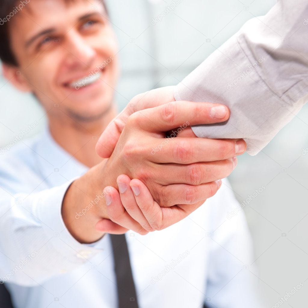Closeup of business shaking hands over a deal