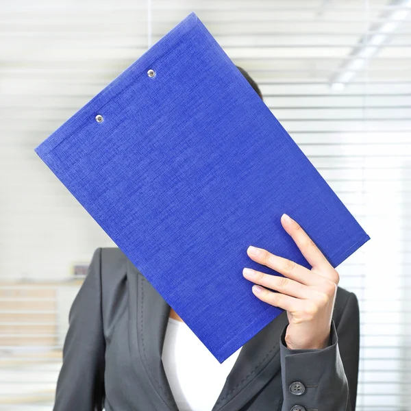 A portrait of a young business woman in an office with documents — Stock Photo, Image