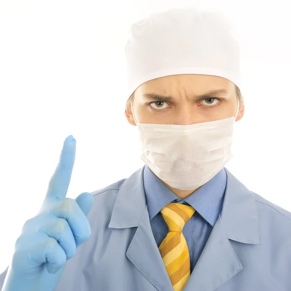 Closeup portrait of a serious young doctor pointing up — Stock Photo, Image