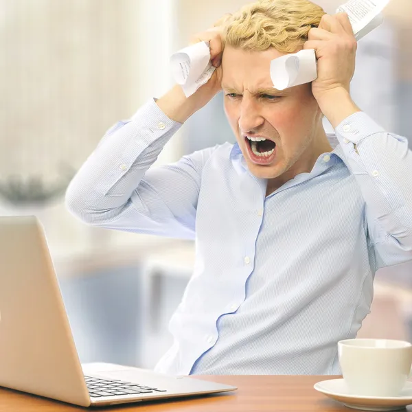Image of young employer touching his head in frustration and cry — Stock Photo, Image