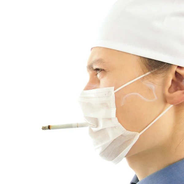 Portrait of young doctor wearing uniform smoking through the bre — Stock Photo, Image