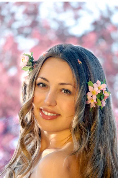 Hezká žena mezi jarní květy — Stock fotografie