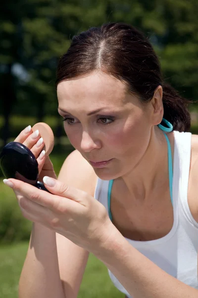 Stock image Woman applying make up