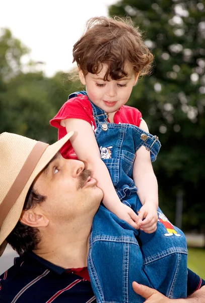 Little girl is on daddy's shoulder — Stock Photo, Image