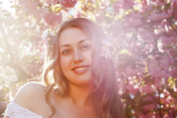 stock image Pretty woman among a spring blossom