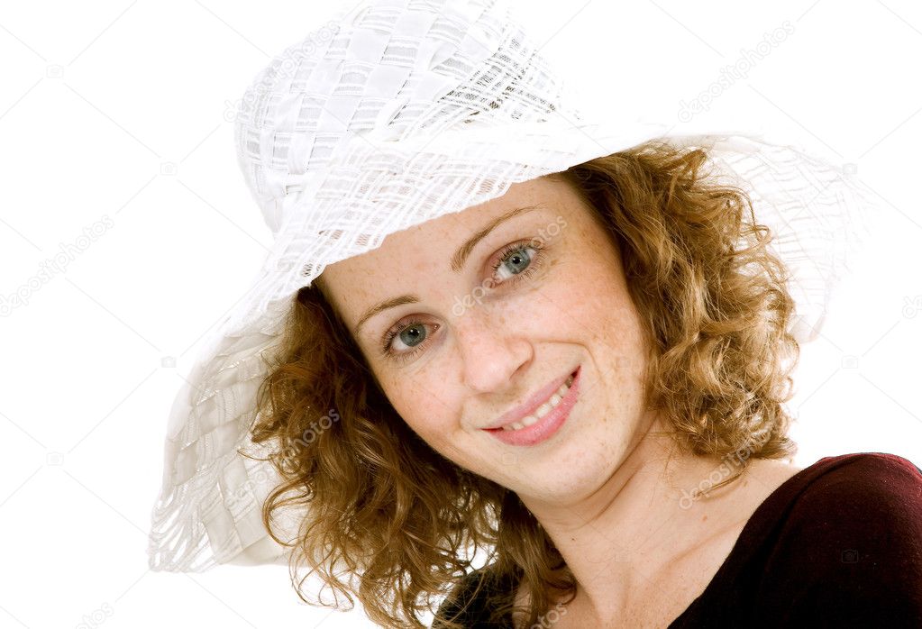 Portrait of red-haired model in a white hat.