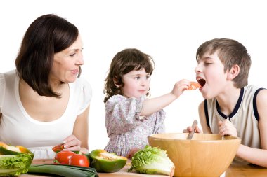 Mother and children cooking at the kitchen clipart