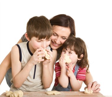 Mother and children making a dough clipart