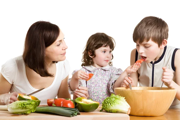 Mother and children cooking at the kitchen — Stock Photo, Image