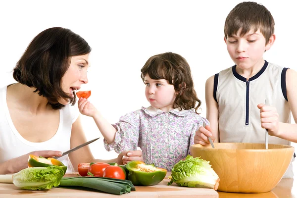 Mother and children cooking at the kitchen — Stock Photo, Image