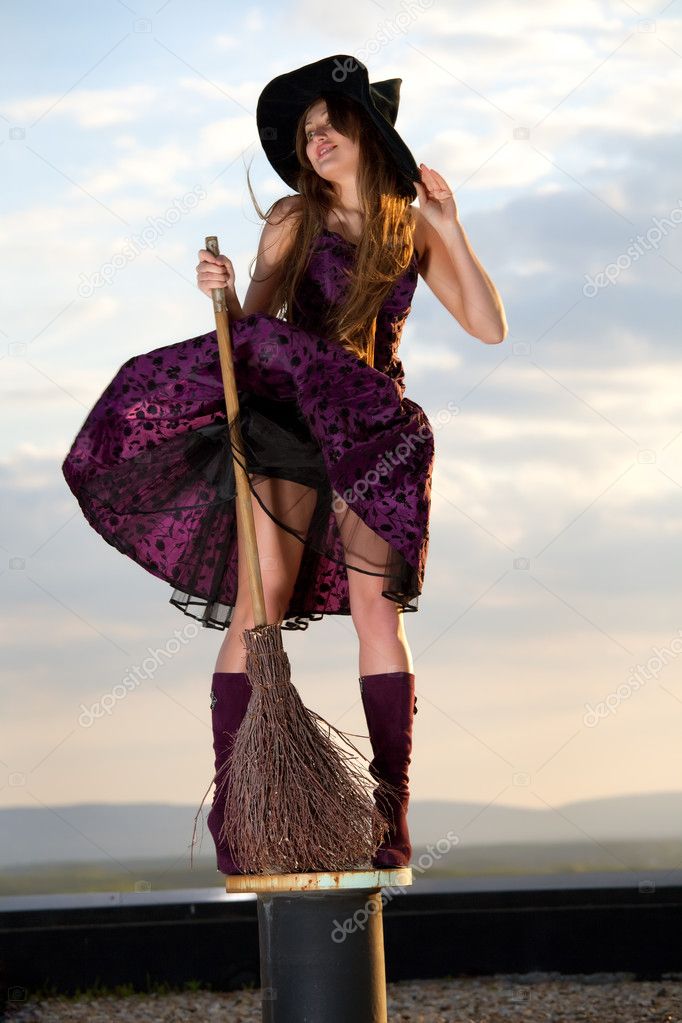 Pretty witch with hat and broom